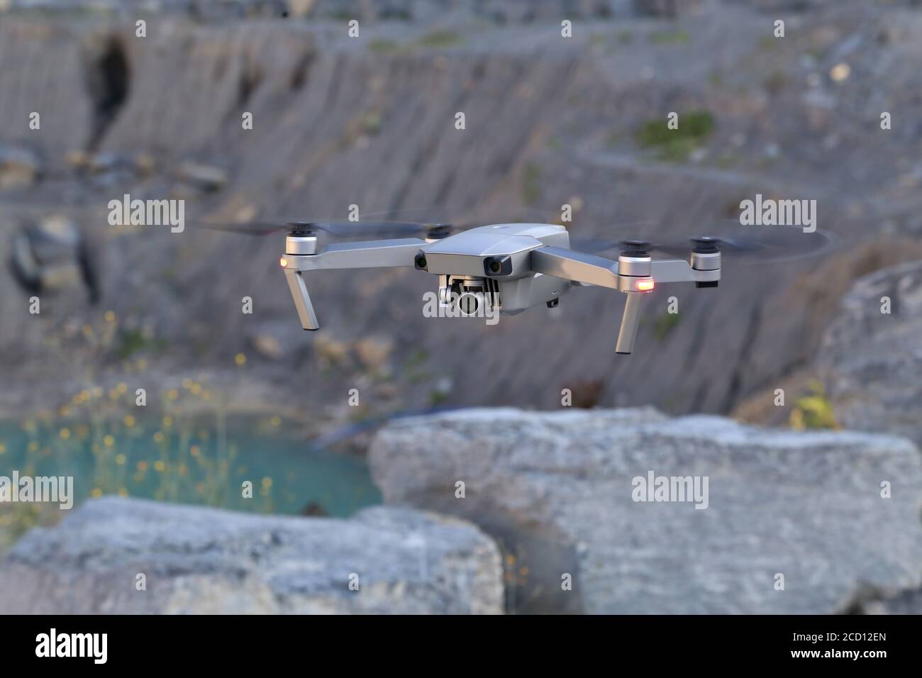 Flying quadcopter with a digital camera on a blurred background Stock Photo