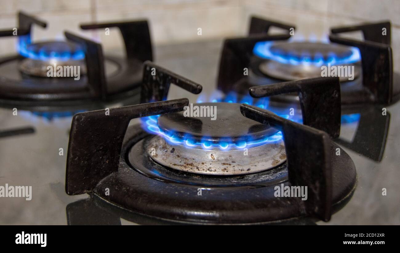 Gas burning out with blue flames on a gas cooker Stock Photo Alamy