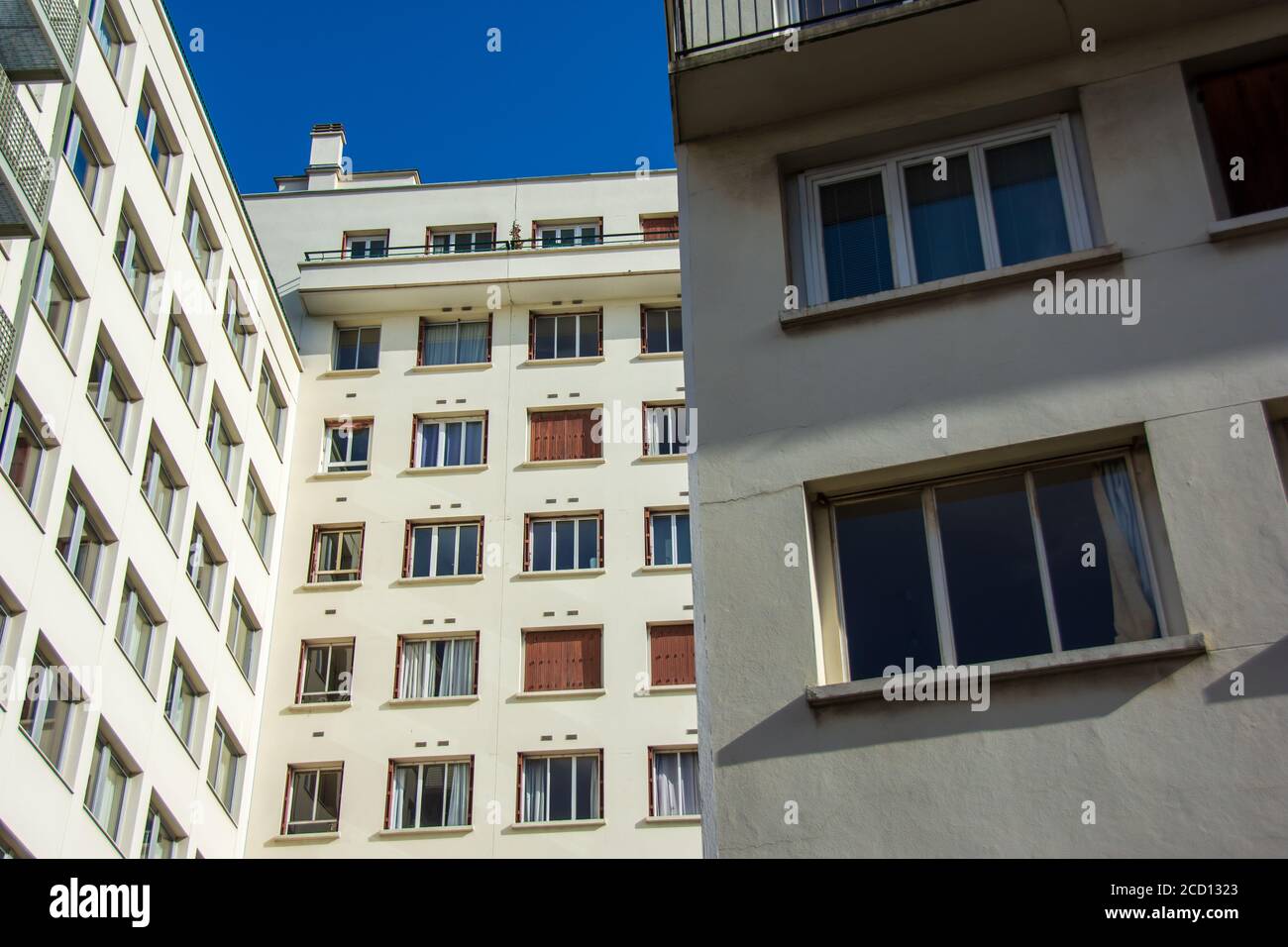 Real estate / housing market: exterior view of residential buildings with many apartment windows Stock Photo