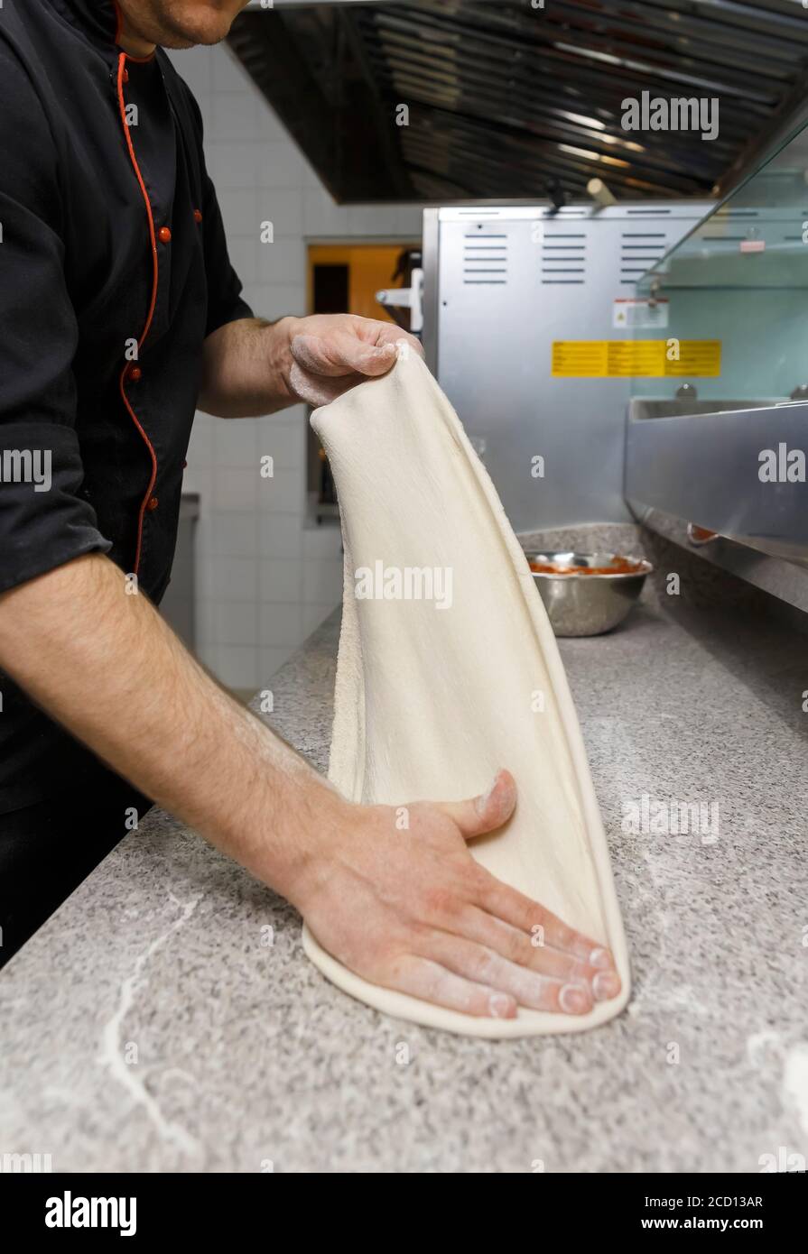 Making dough by male hands on table background. Pizza maker prepares a ...