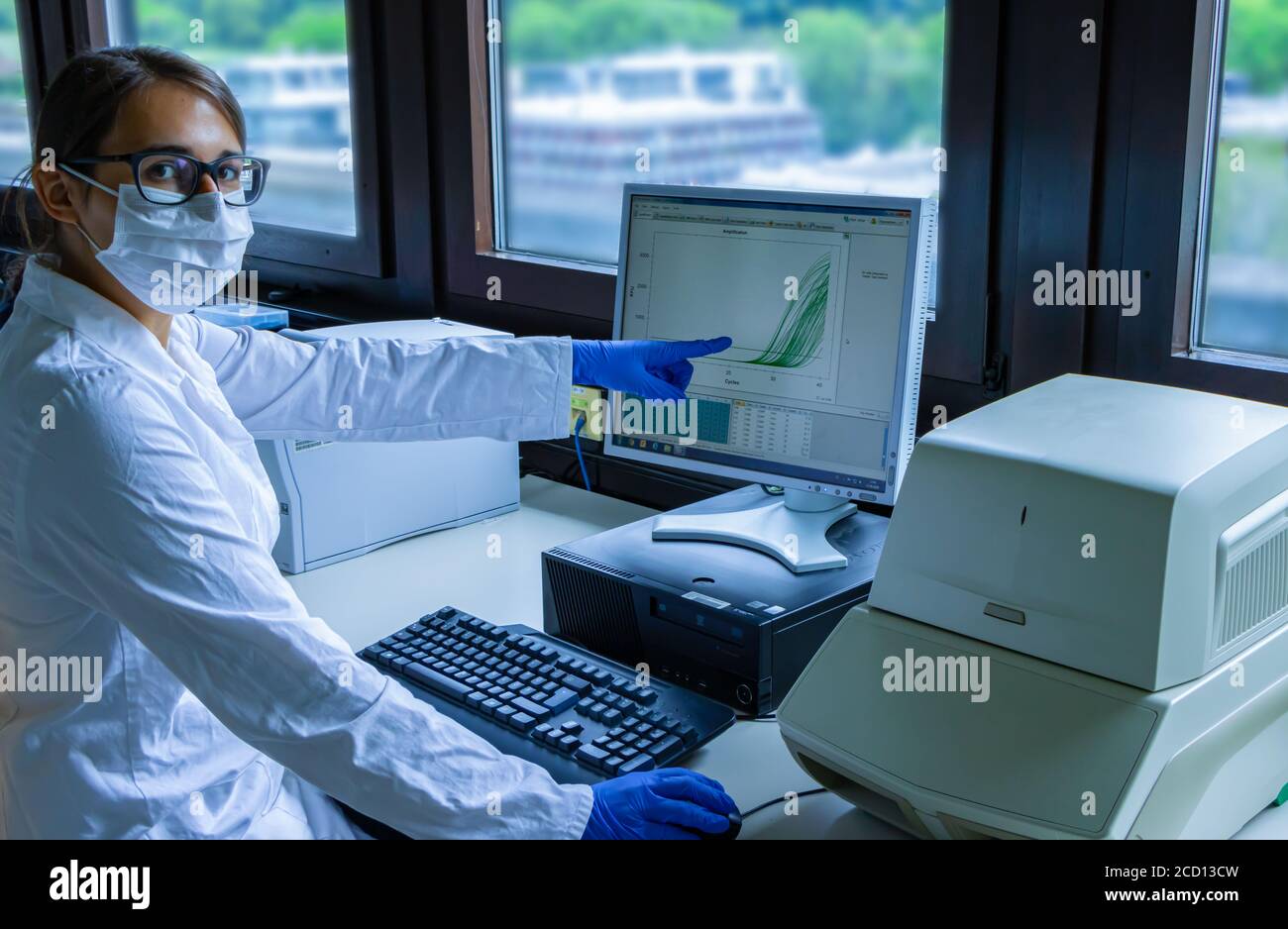 Female scientist explaining corona virus test Stock Photo