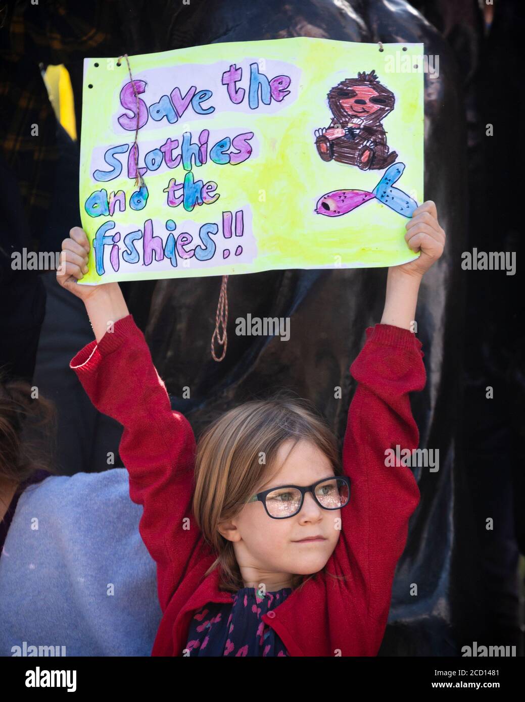 A young girl holding up a cute protest sign during the Climate Strike, London, 20 September 2019 Stock Photo