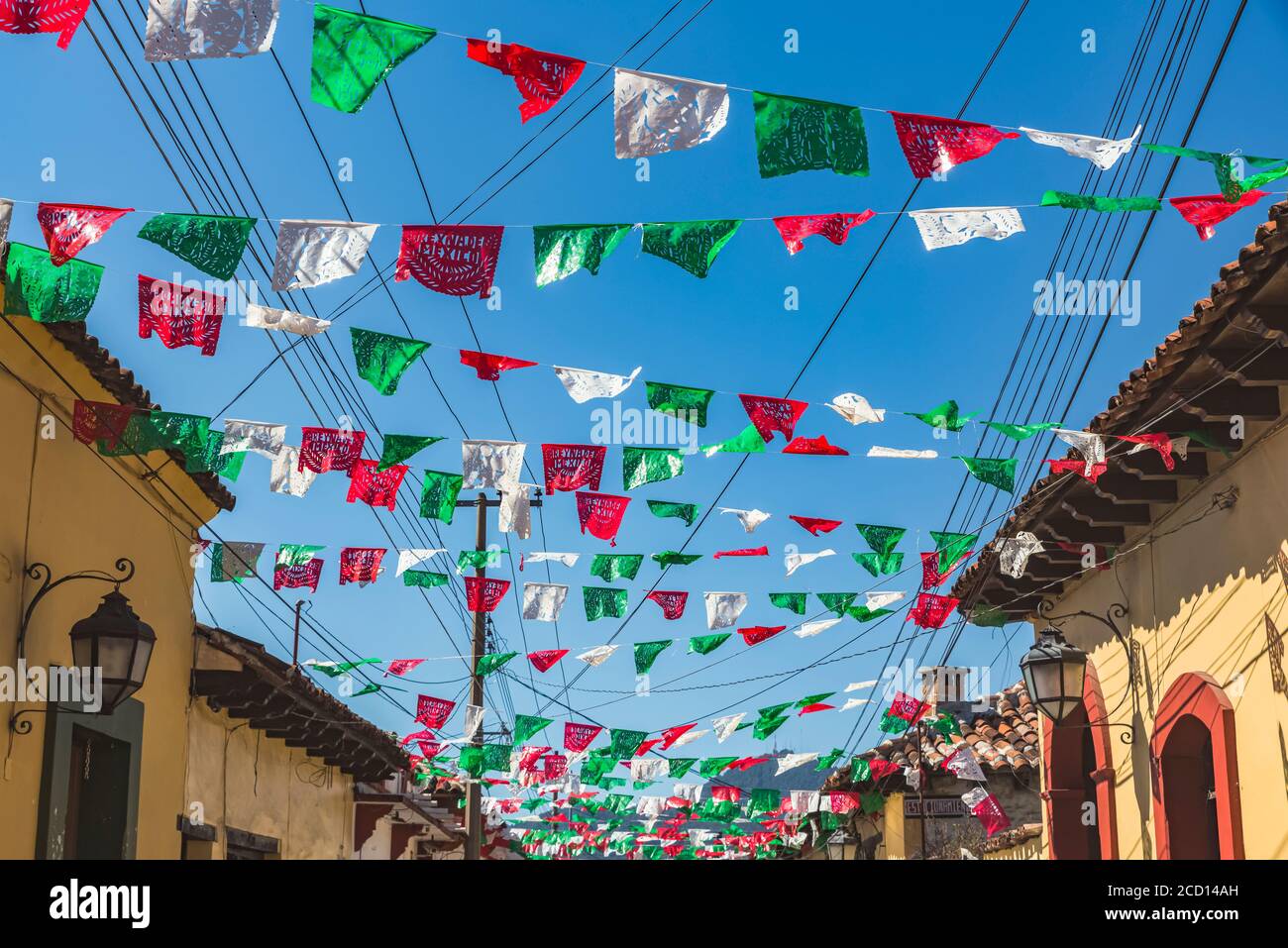 Garlands strung across a street between buildings; San Cristobal de las Casas, Chiapas, Mexico Stock Photo