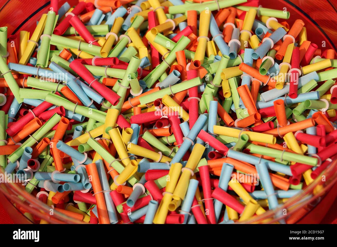 Closeup shot of a lot of colorful tombola tickets in a bowl Stock Photo