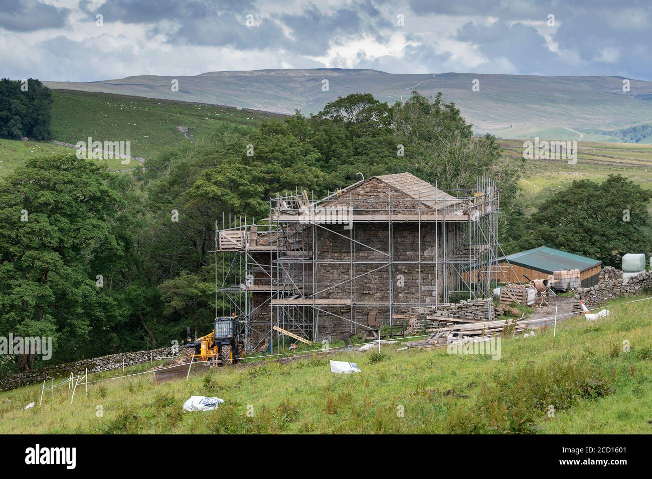 Barn in the Yorkshire Dales National Park, with scaffolding around it, being converted into a house. UK. Stock Photo