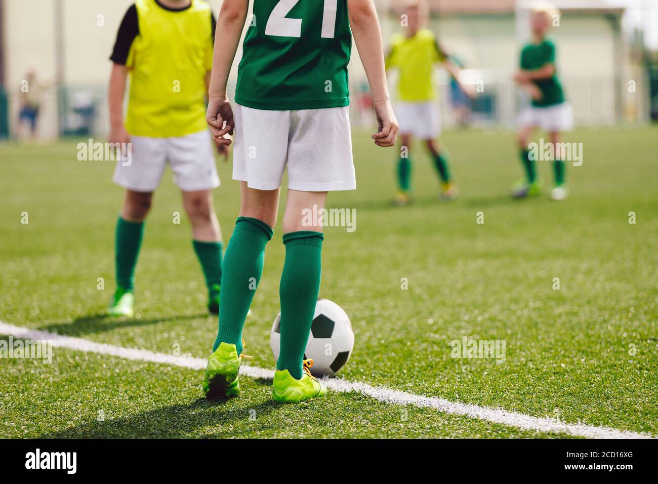 School soccer football game. Kids running after soccer ball on grass field. Sports competition between children sport players Stock Photo