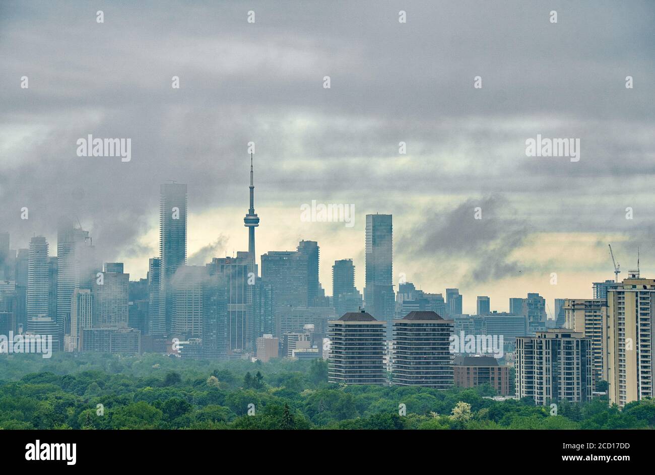 Toronto landmark buildings are partially veiled with dark stormy clouds in summer Stock Photo