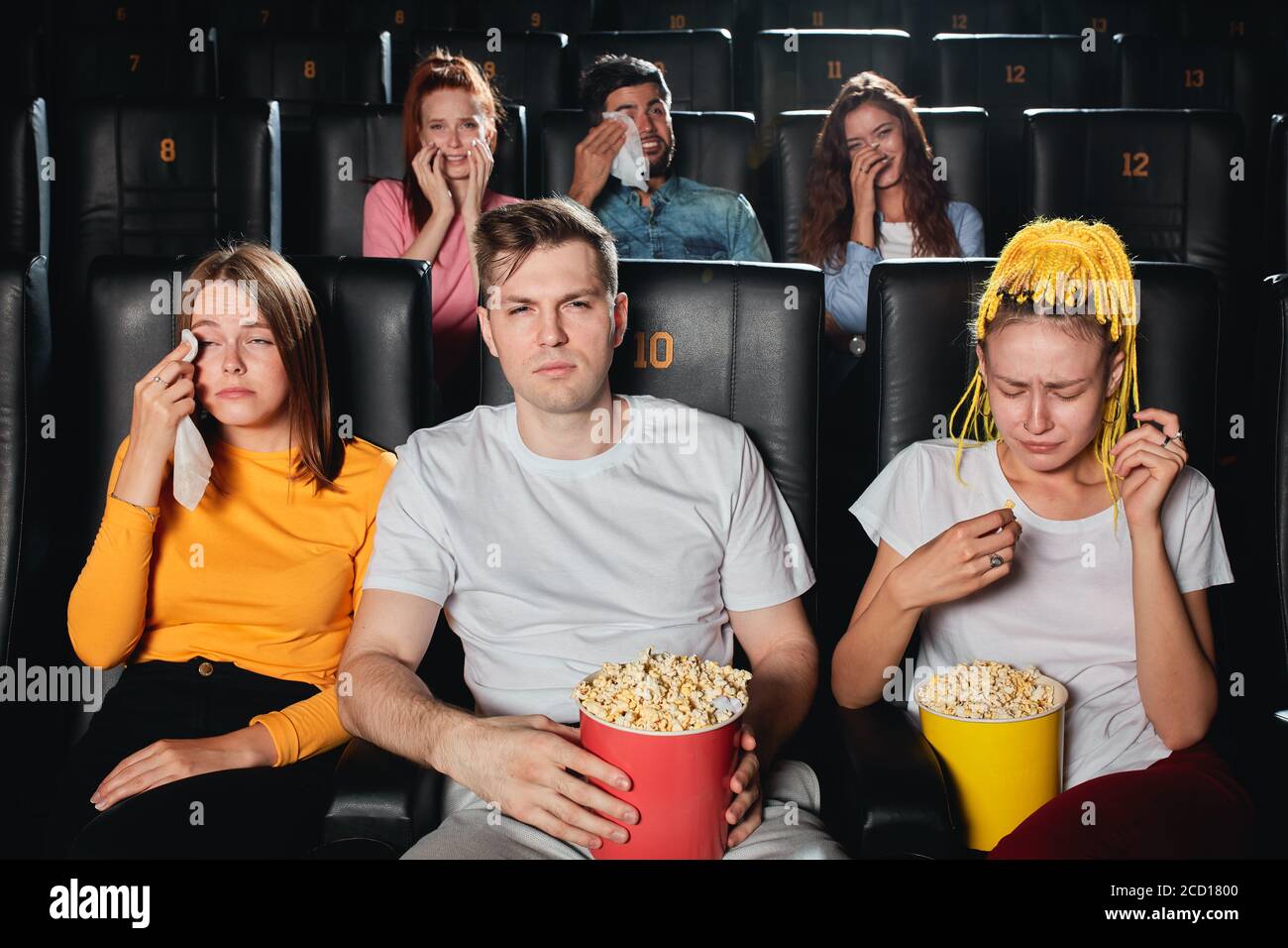 emotional young people watching movie about love,negative feeling and emotion, reaction concept Stock Photo