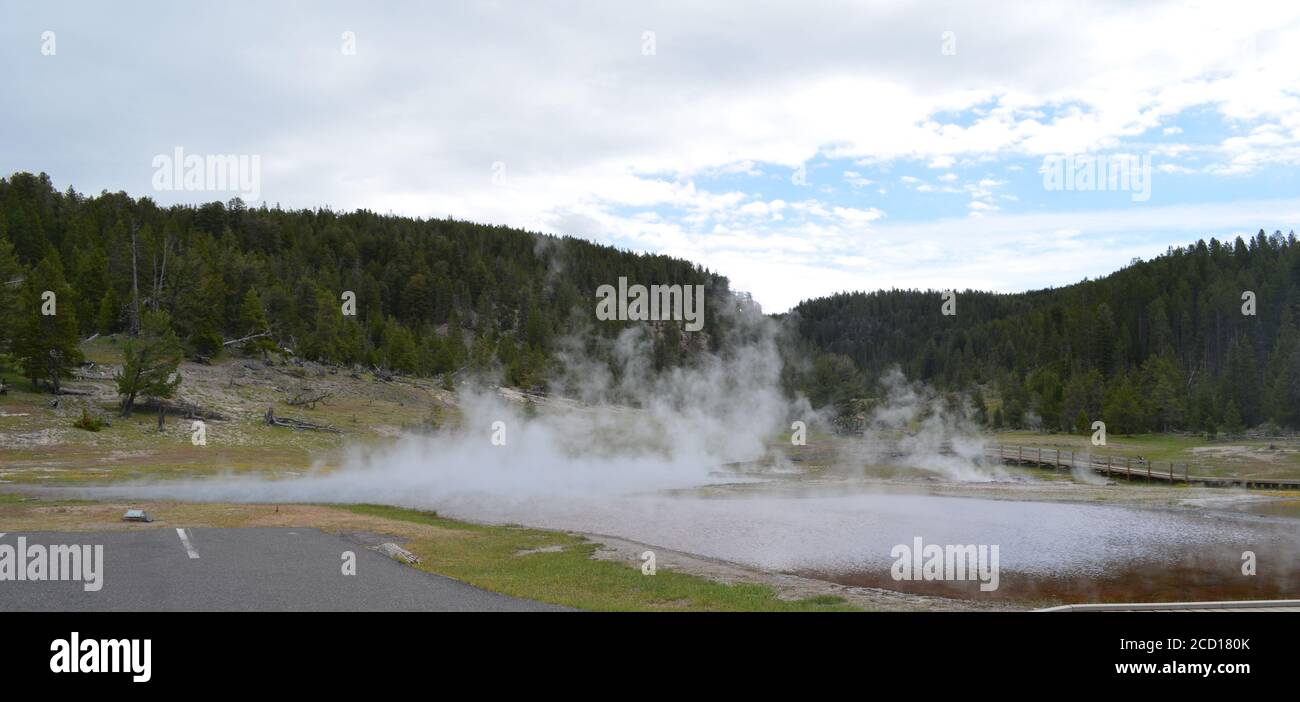 YELLOWSTONE NATIONAL PARK, WYOMING - JUNE 9, 2017: Firehole Lake, Gray Bulger Geyser, Young Hopeful Geyser & Artesia Geyser of the Black Warrior Group Stock Photo