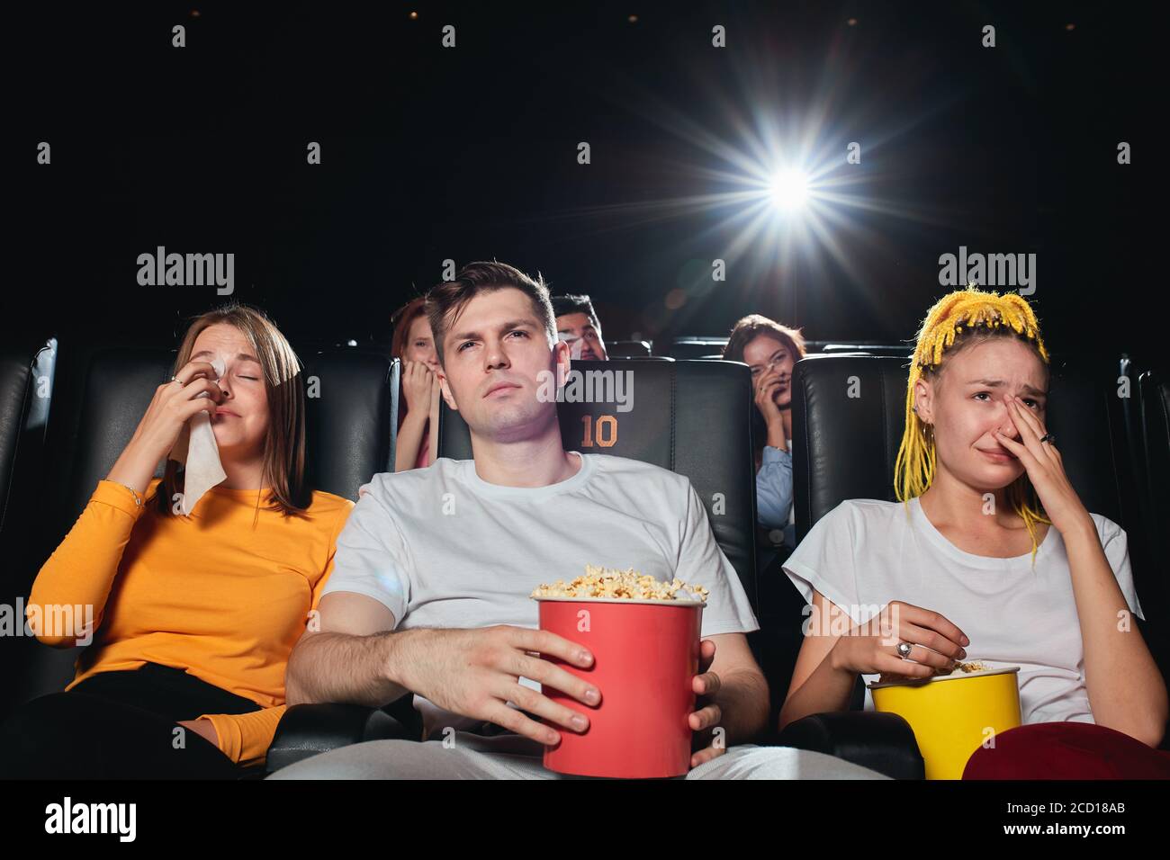 Friends crying while watching sad film at the cinema, close up photo.depression concept Stock Photo