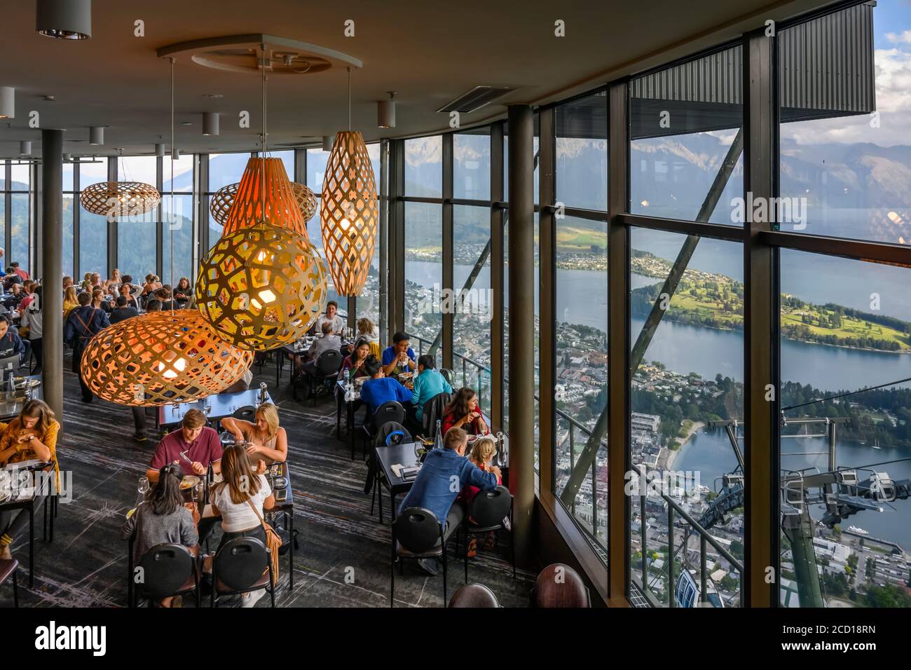 Restaurant with glass walls overlooking Lake Wakatipu; Queenstown, Otago Region, New Zealand Stock Photo