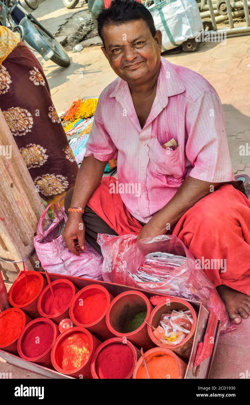 Man selling powder dyes outside Shree Jagannath Temple; Puri, Odisha State, India Stock Photo