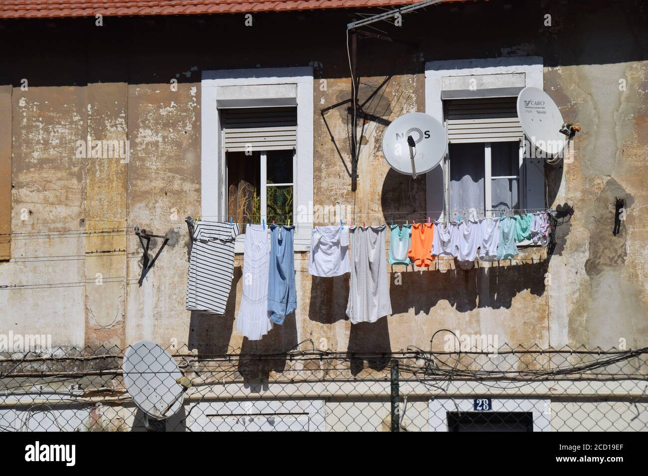 Cloths hanged on window in Lisbon Portugal Stock Photo