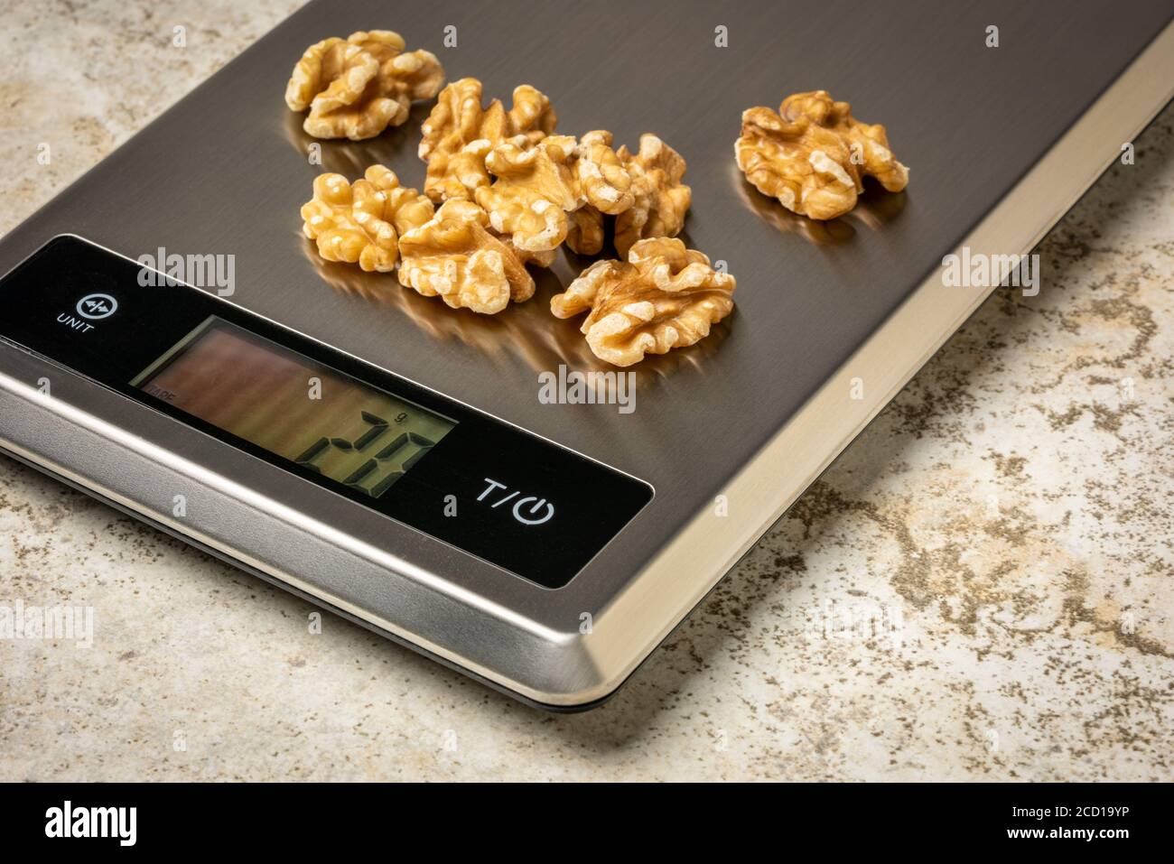 walnuts on a digital nutrition diet scale, healthy eating concept Stock Photo Alamy
