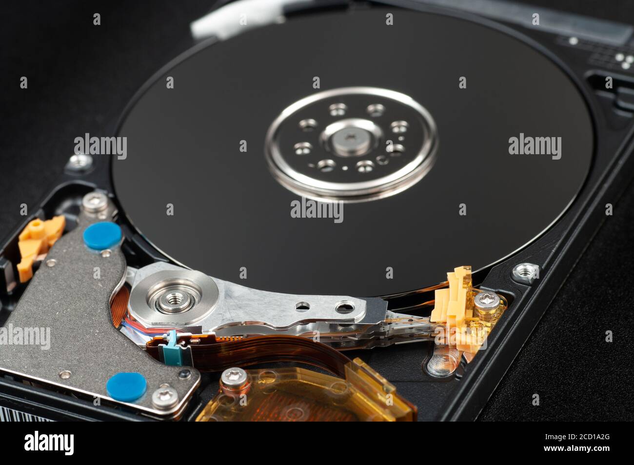 Disassembled laptop hard disk drive, hdd. Close-up. Opened hard drive, magnetic heads and disk plates Stock Photo