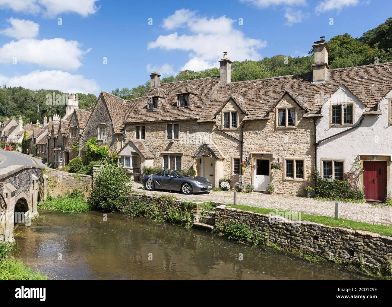 Old stone cottages and River Bybrook, “Castle Combe” village, Wiltshire ...