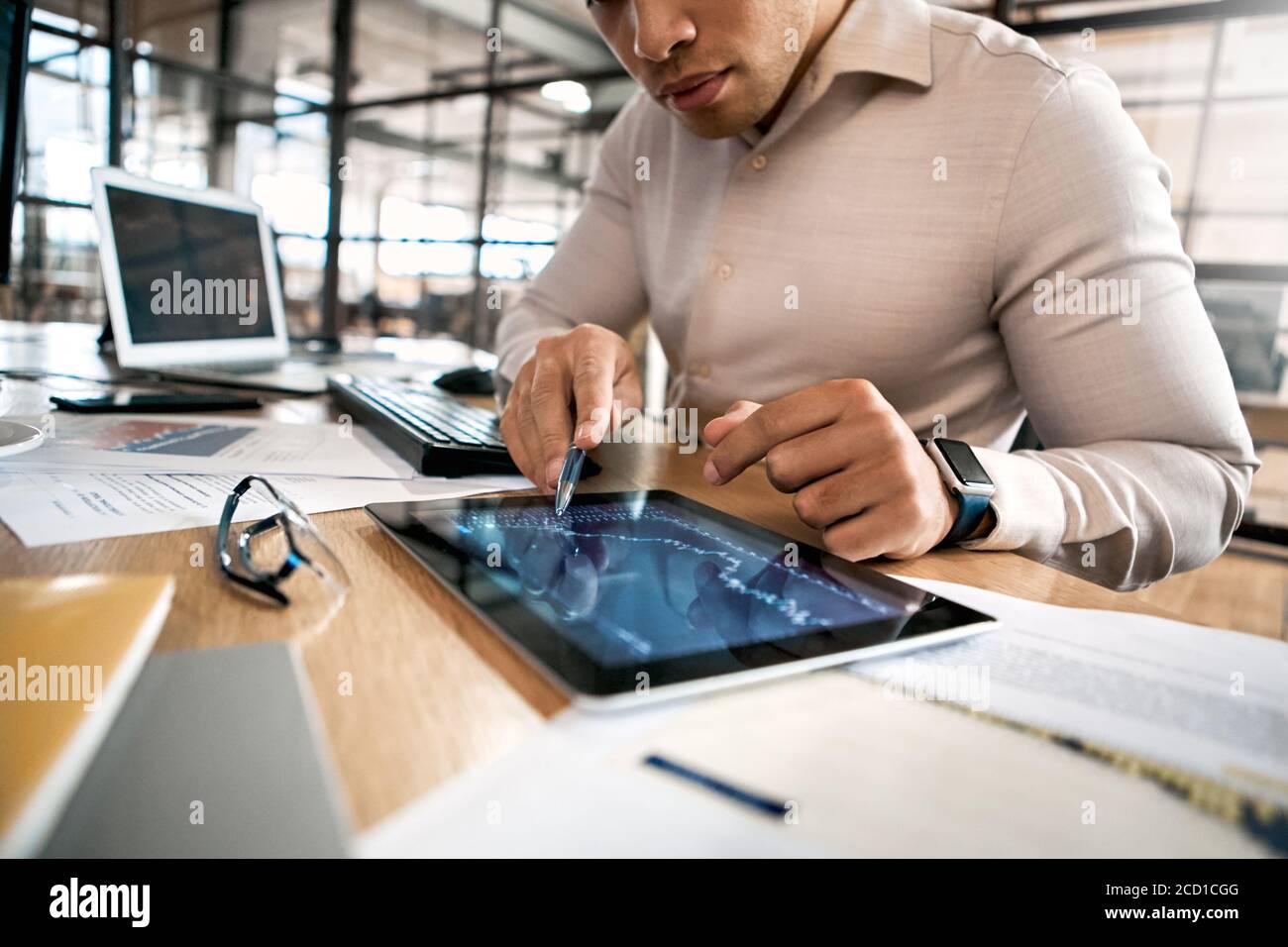 Businessman analyzing stat and dynamic on forex charts at tablet computer Stock Photo