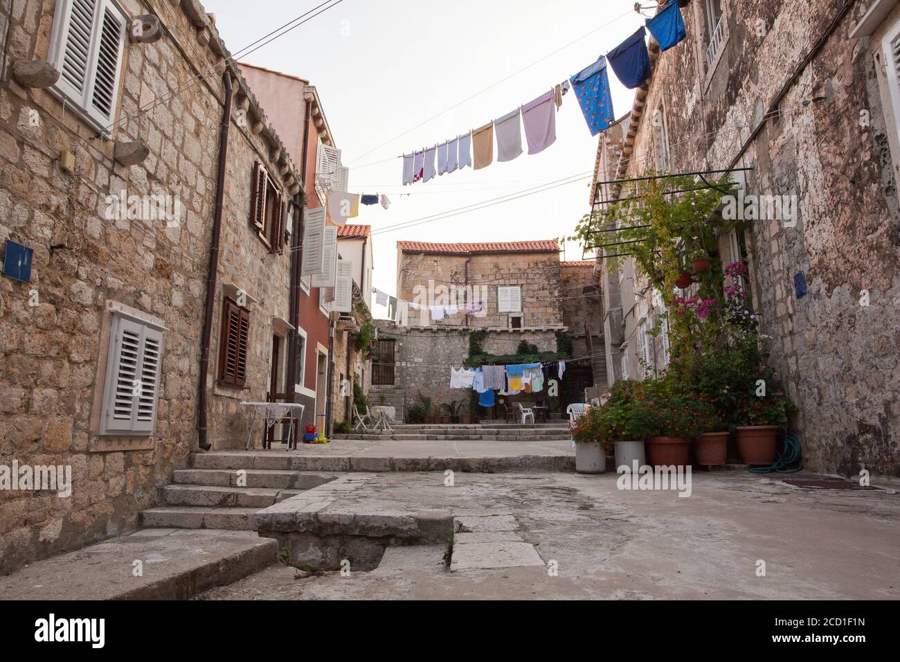 Washing lines in an alley in Dubrovnik. Clothes hanging to dry on the rope. Laundry hanging between houses in old European city Stock Photo