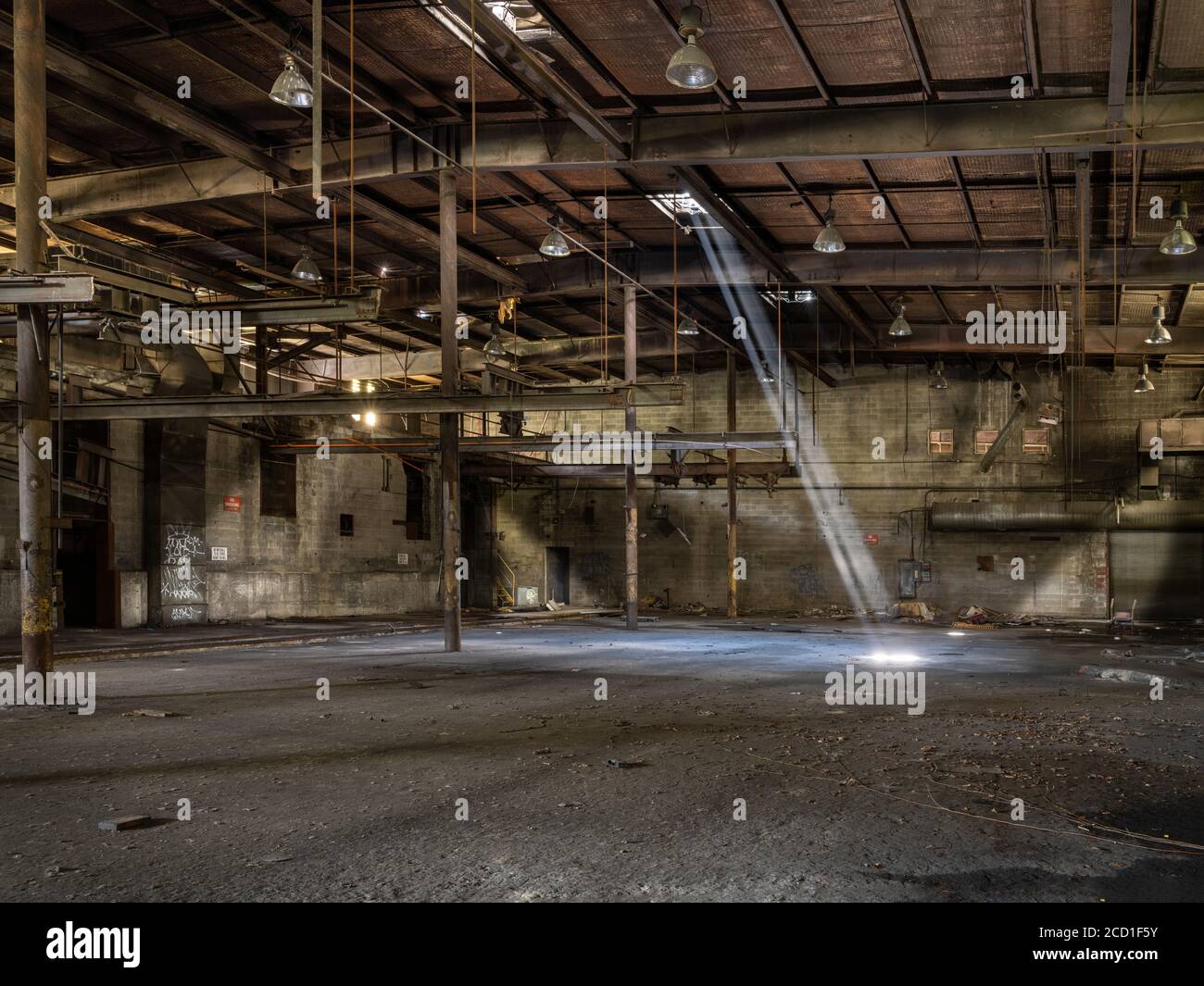 Shat of light shining down in to abandoned factory, Conshohocken, Pennsylvania USA Stock Photo