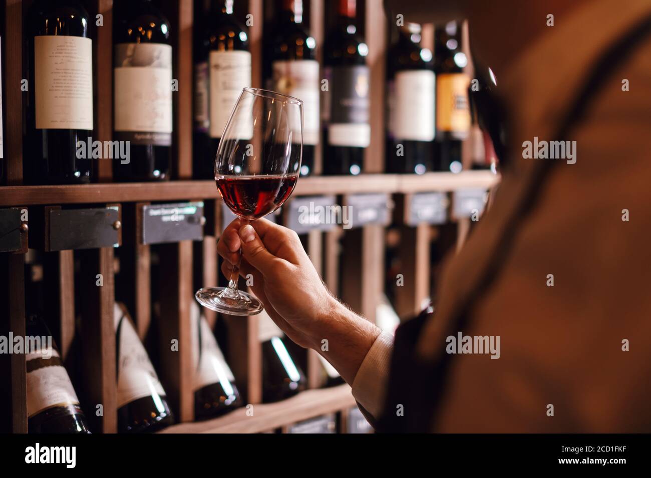 Front View On Wineglass Standing On Bar And Bartender Holding