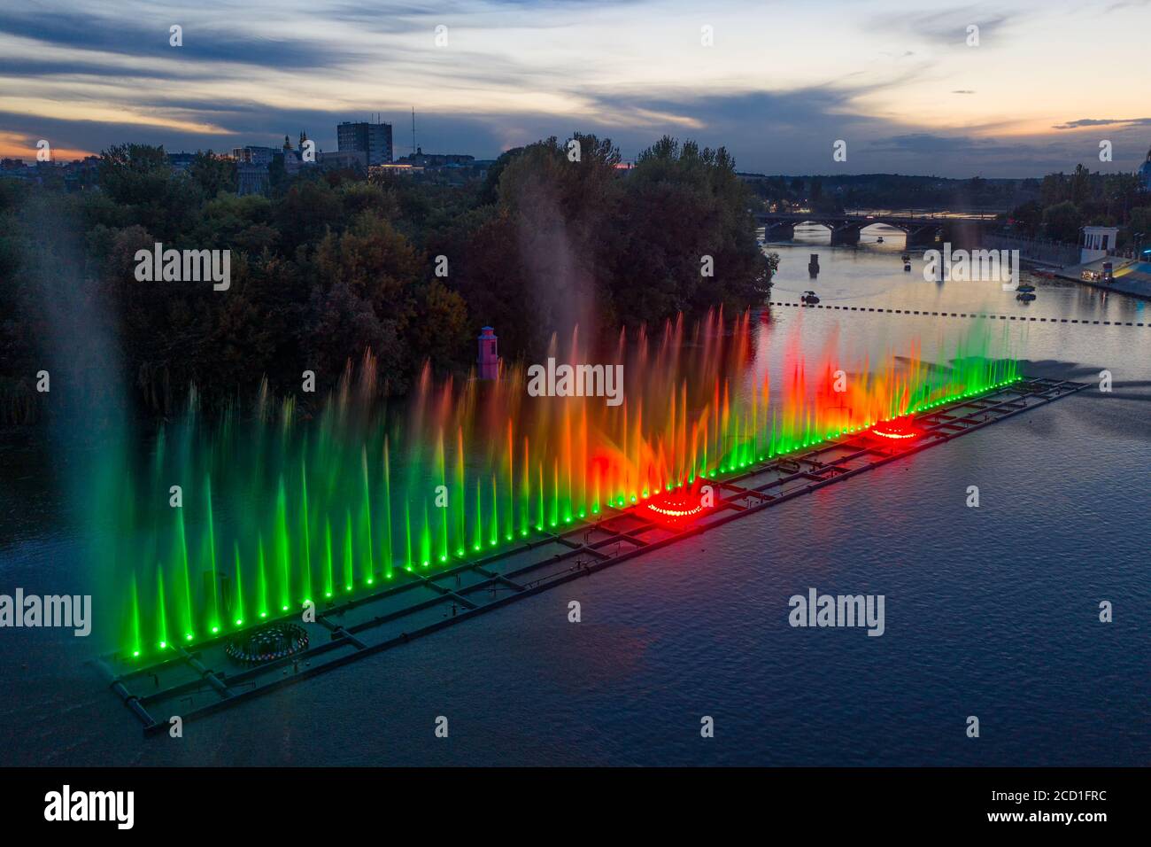 Colored fountain on the river at night Stock Photo - Alamy