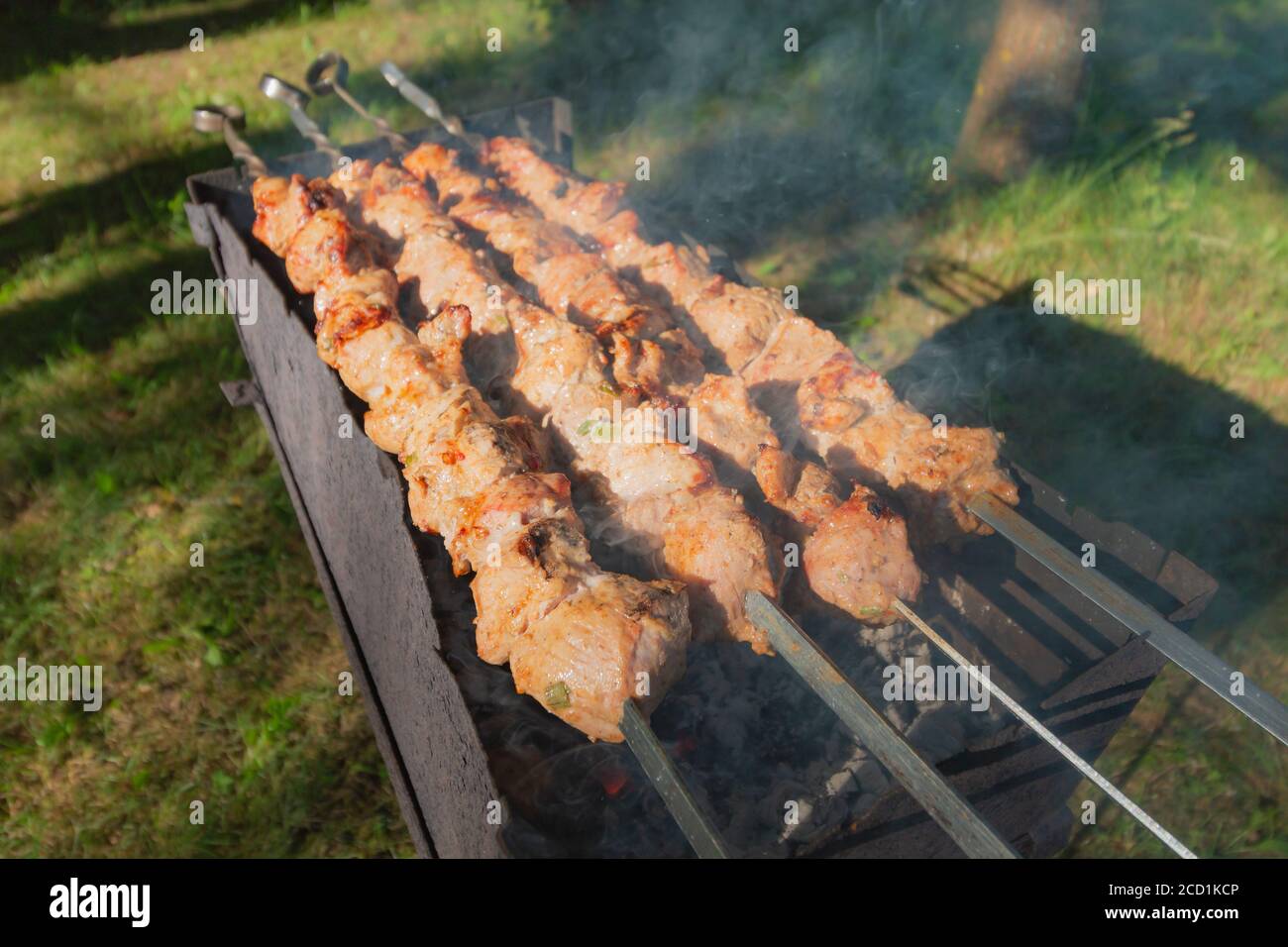 Shashlik or shashlyk preparing on a barbecue grill over charcoal Stock Photo