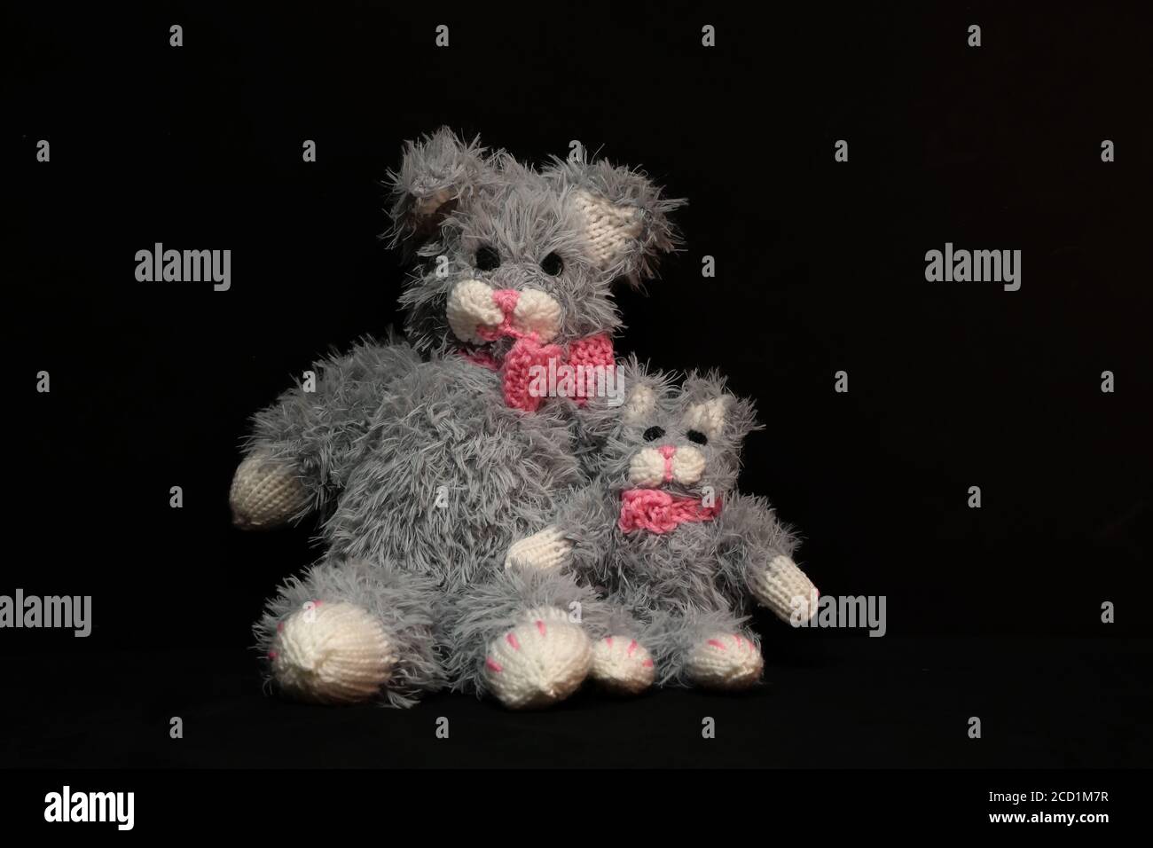 Closeup of two knitted gray bears on a black background Stock Photo