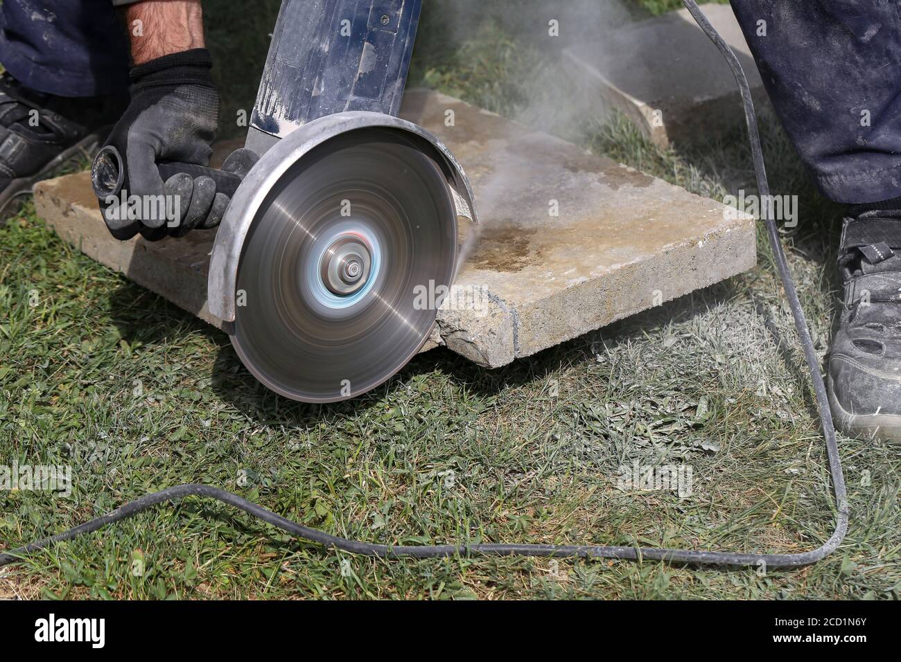Industrial construction worker using a professional angle grinder Stock Photo