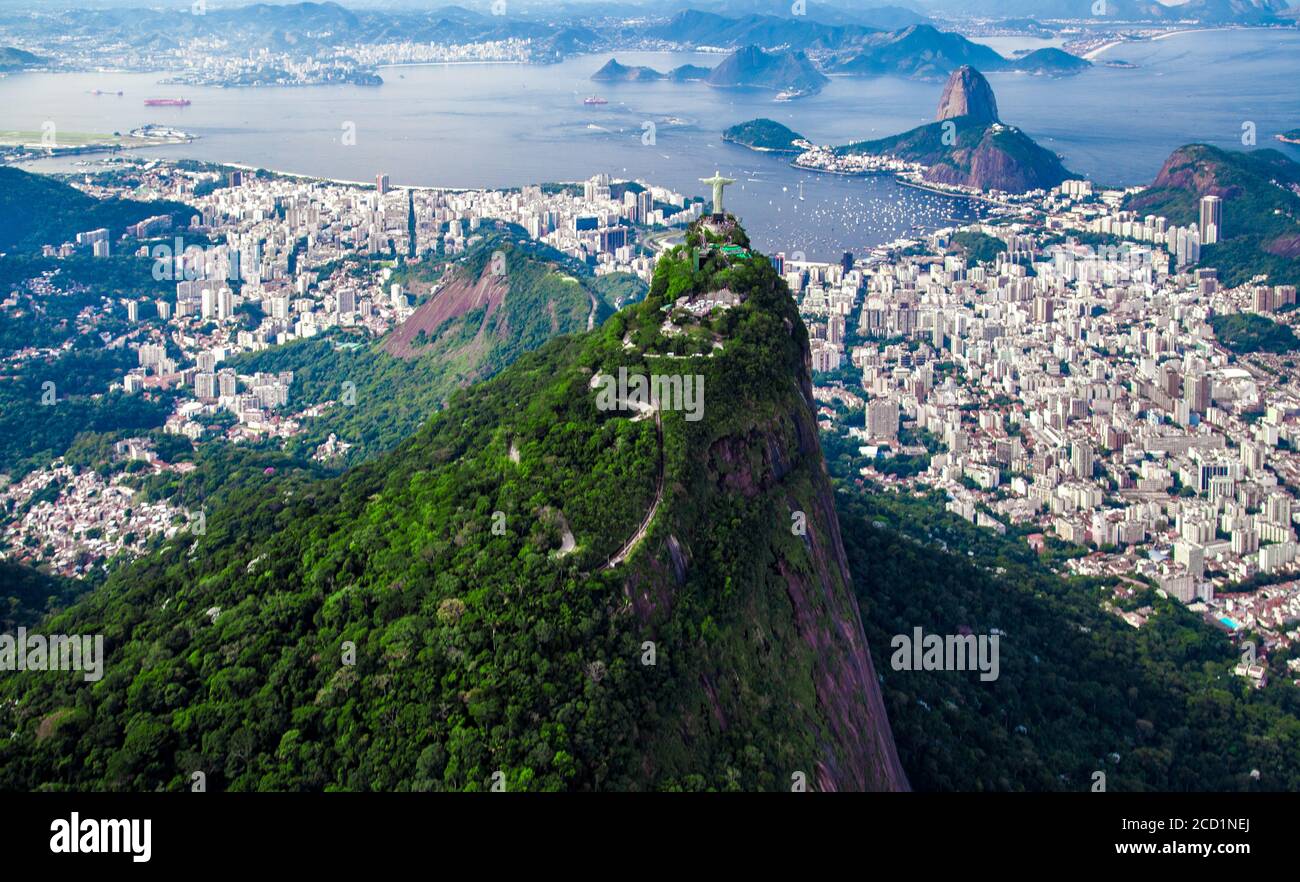 Aerial view of Christ the Redeemer overlooking Sugarloaf Mountain (Pao de Açúcar) and the city skyline of Rio de Janeiro, Brazil Stock Photo