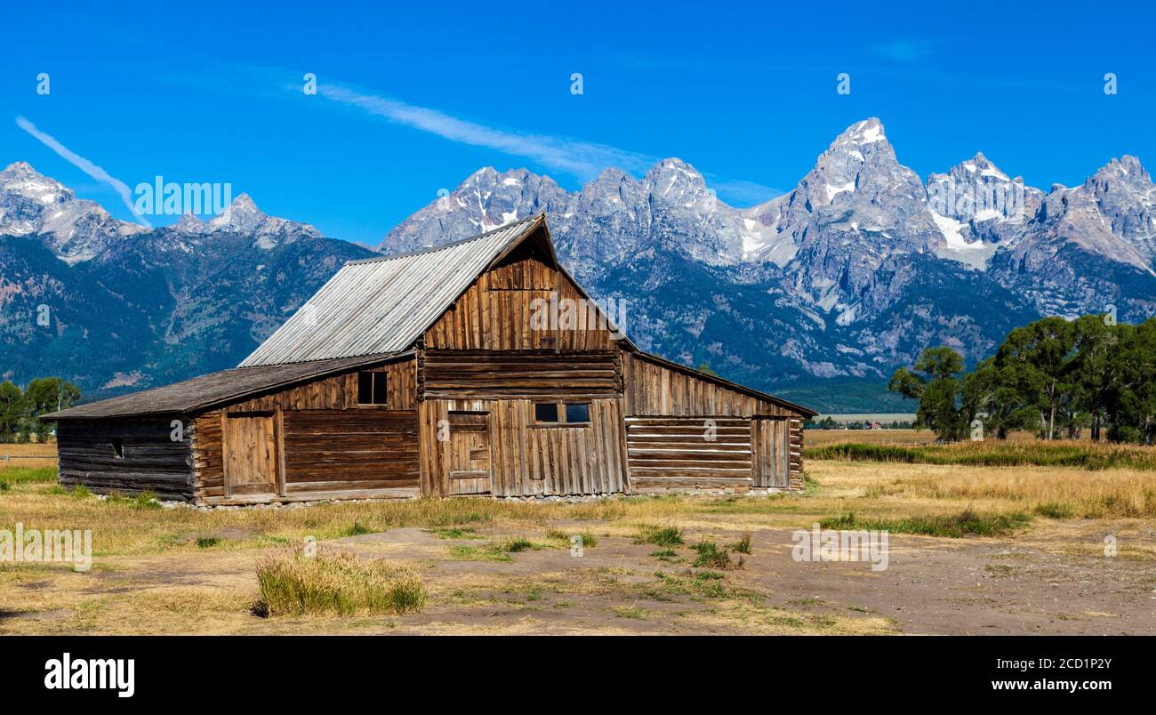 T.A. Moulton Barn at Grand Teton National Park just after sunrise near Jackson, Wyoming. Grand Teton can be seen be seen in the background. Stock Photo