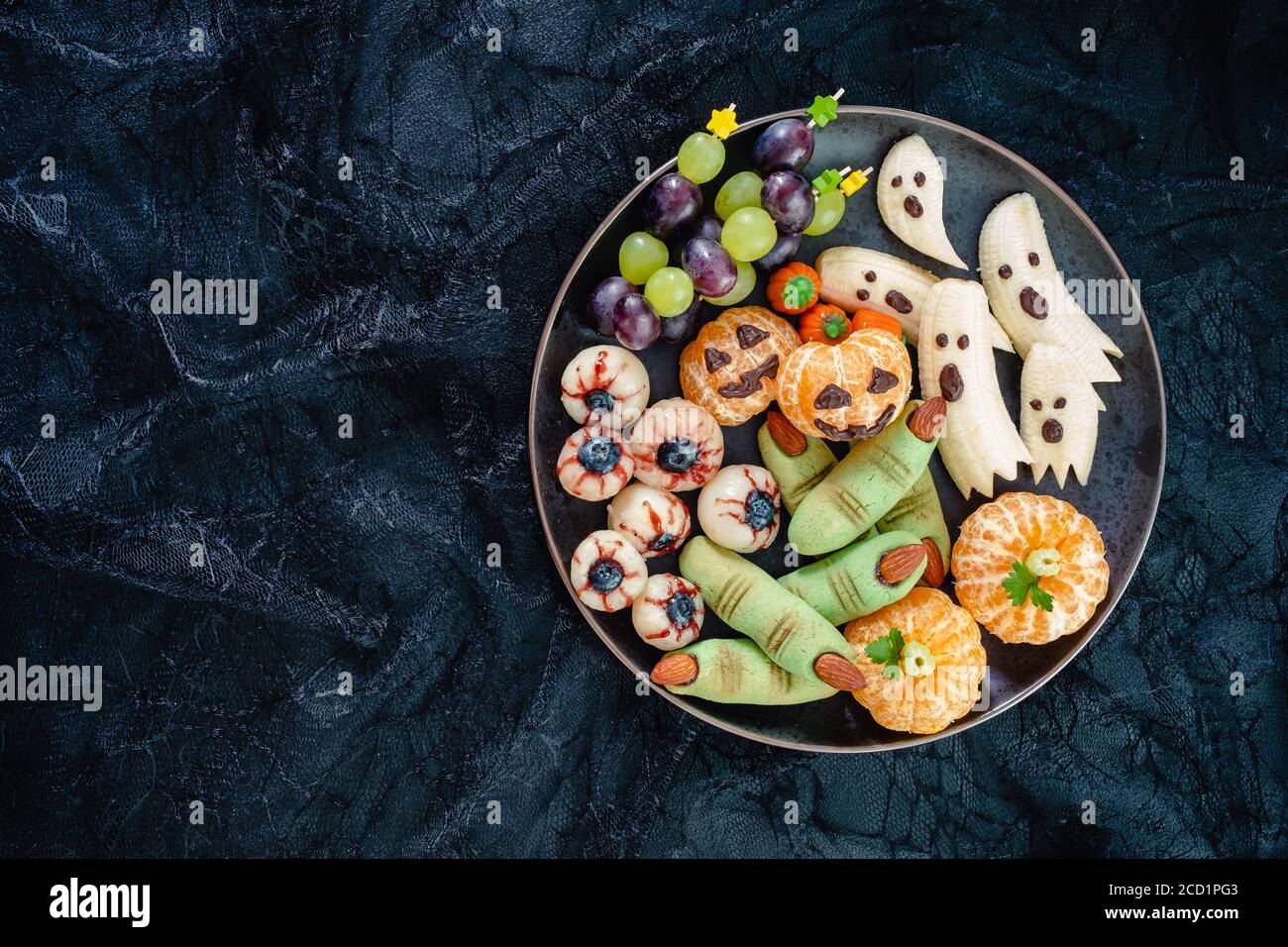 Healthy Fruit Halloween Treats. Banana Ghosts, Clementine Orange Pumpkins and Lychee Eyes Stock Photo