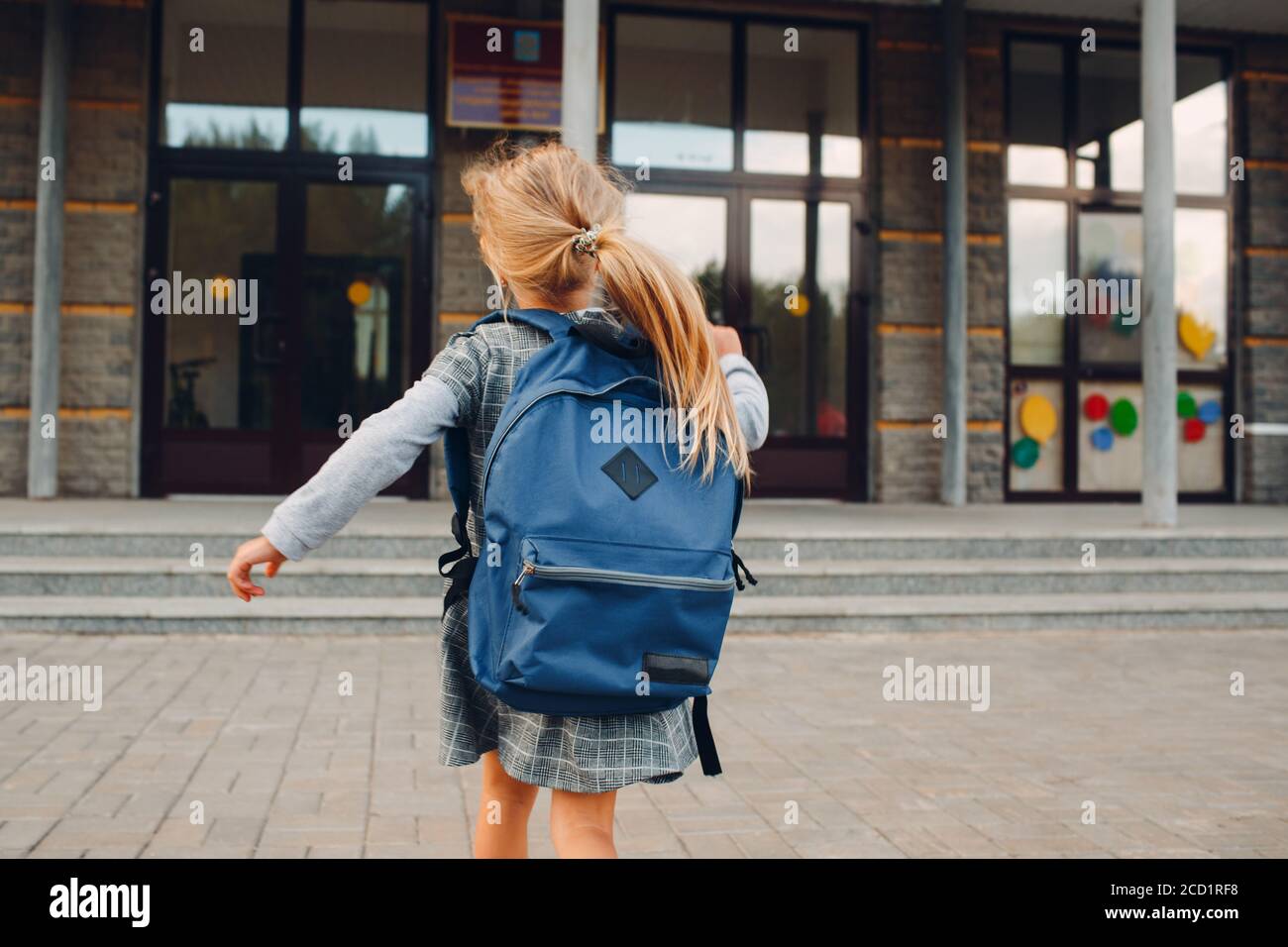 Cute little girl with backpack running back to school Stock Photo Alamy