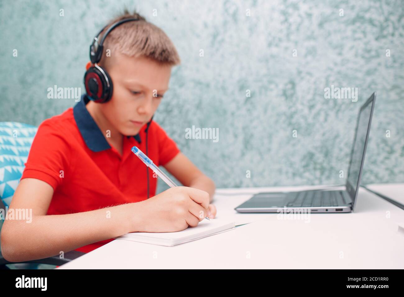 Young student boy with laptop write pen learning and preparing back to