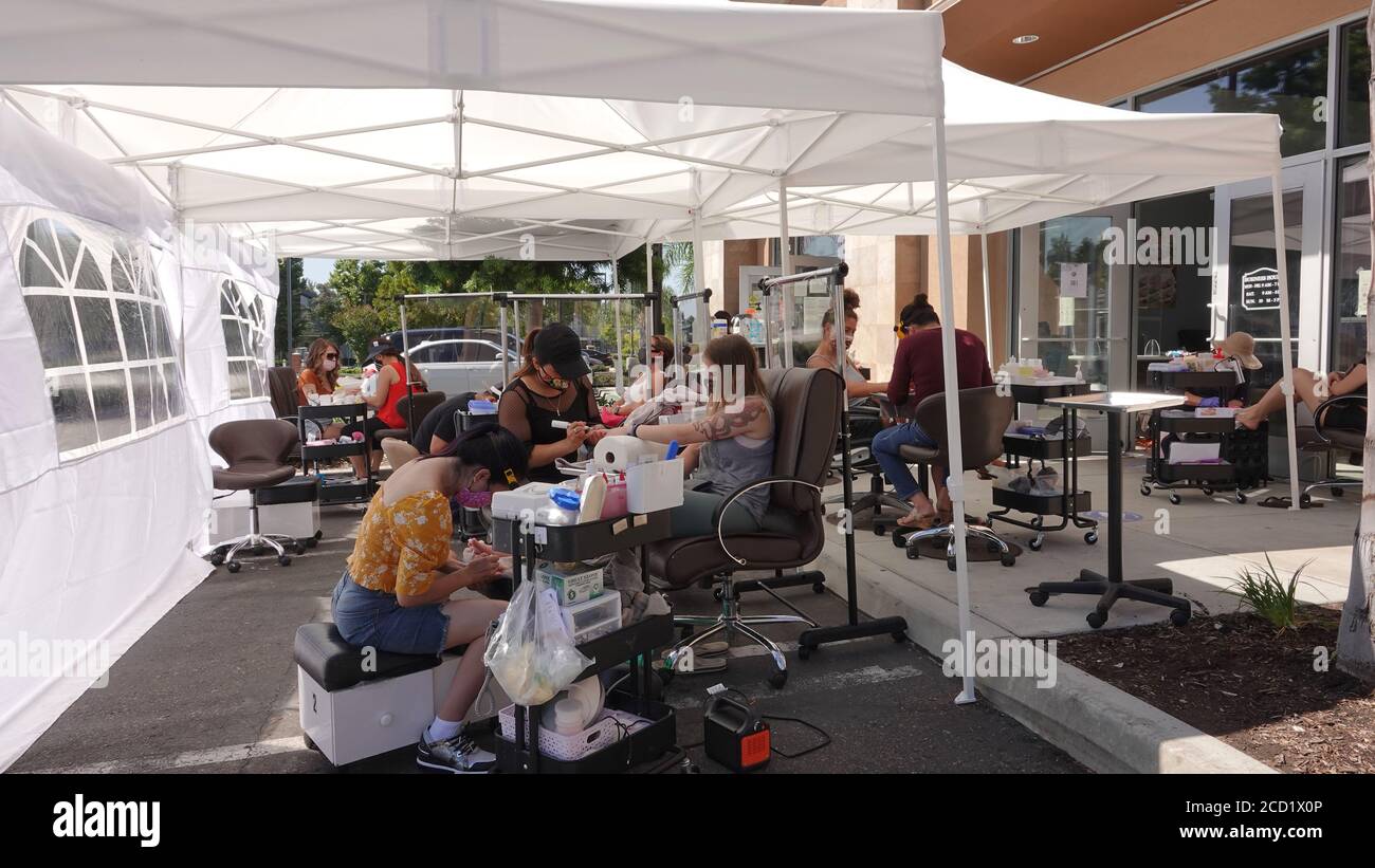 Vista, CA / USA - August 1, 2020: A nail salon has moved its operations outside to avoid having to close again during times of Covid-19. Stock Photo