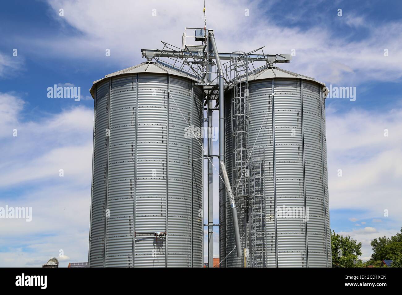Beautiful shot of Metallic silos in white over the sky Stock Photo