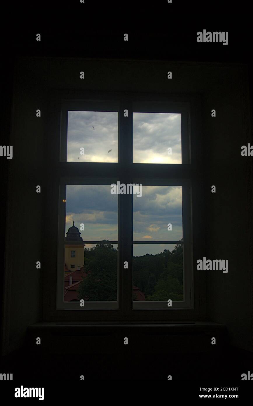 A green and castle view out of a window Stock Photo