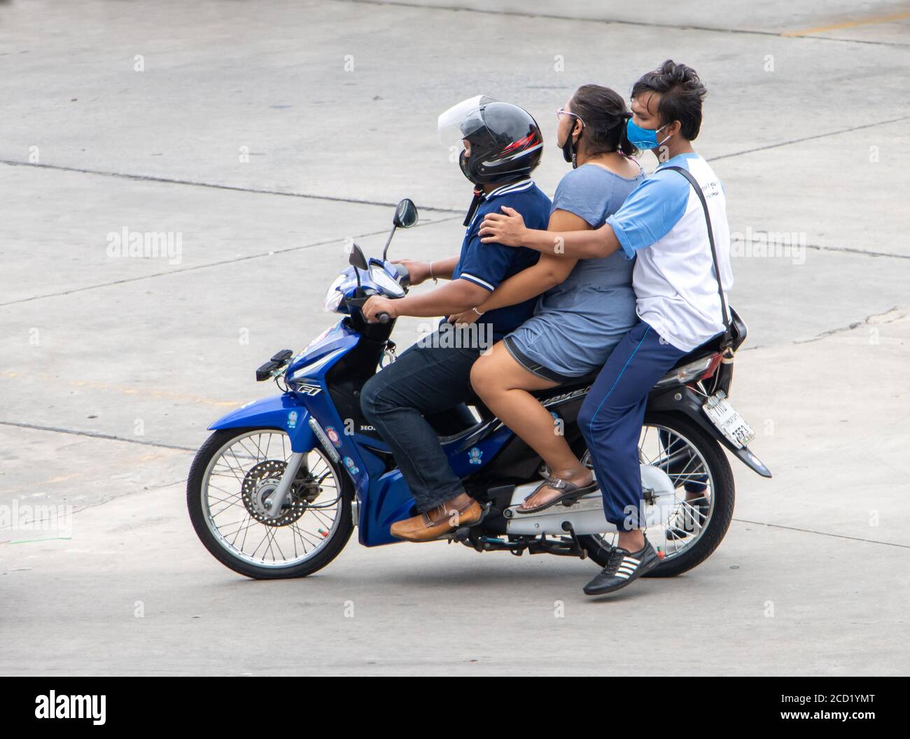 SAMUT PRAKAN, THAILAND, JUL 03 2020, The group of three adult people rides  on a motorcycle Stock Photo - Alamy