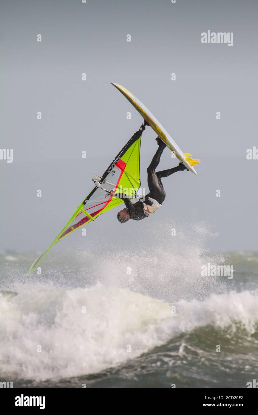 Airborne Windsurfer Somersaulting After Jumping A Large Wave Executing A Front Loop During Storm Francis At Avon Beach Christchurch UK August 25 2020 Stock Photo