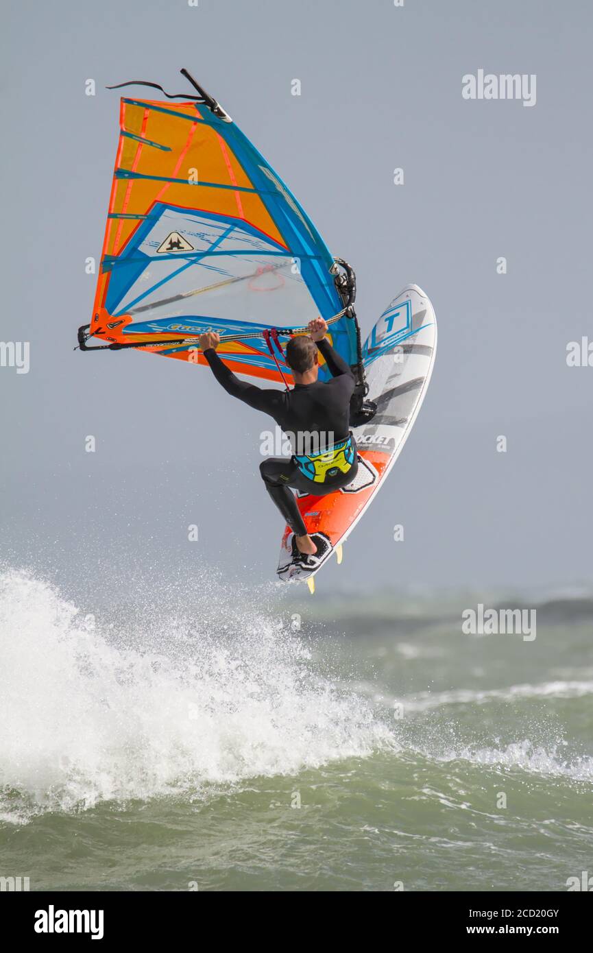 Airborne Windsurfer Jumping Waves At Avon Beach Christchurch UK During Storm Francis August 25 2020 Stock Photo