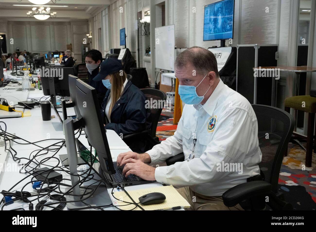 Austin, TX USA August 25, 2020: State employees wearing face mas work at the Texas Emergency Operations Center during preparations for Hurricane Laura, scheduled to make landfall in coastal east Texas and southwest Louisiana on Thursday. Credit: Bob Daemmrich/Alamy Live News Stock Photo