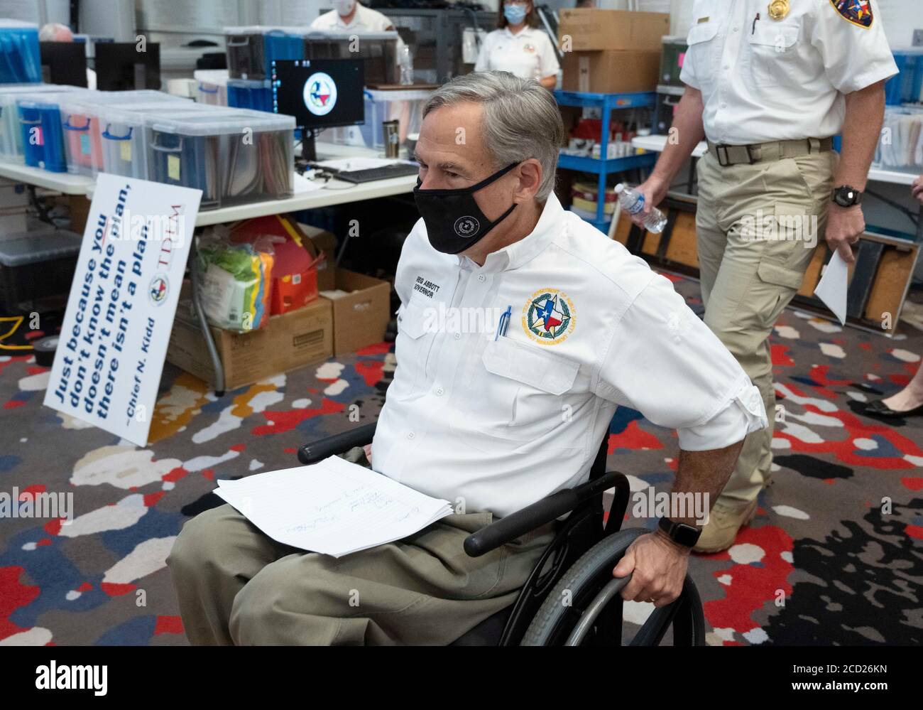 Austin, TX USA August 25, 2020: Texas Gov. Greg Abbott, wearing a face mask, enters the state Emergency Operations Center to hear a report on the state's preparations for Hurricane Laura, scheduled to make landfall in coastal east Texas and southwest Louisiana on Thursday. Abbott mobilized hundreds of state resources as Texans remember the extreme damage done by Hurricane Harvey in 2017. Abbott has been confined to a wheelchair since a falling tree limb fell on him in 1984. Credit: Bob Daemmrich/Alamy Live News Stock Photo
