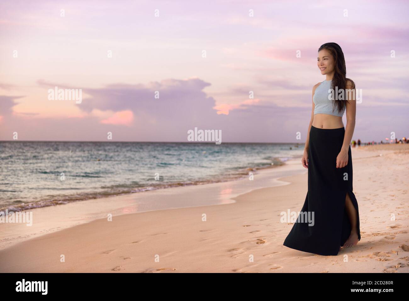 Asian model woman walking on beach at 