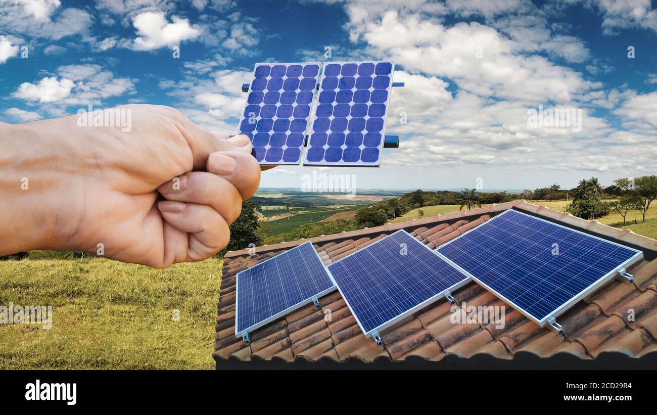 Holding a calculator on a solar panel photovoltaic installation in the  background Stock Photo - Alamy