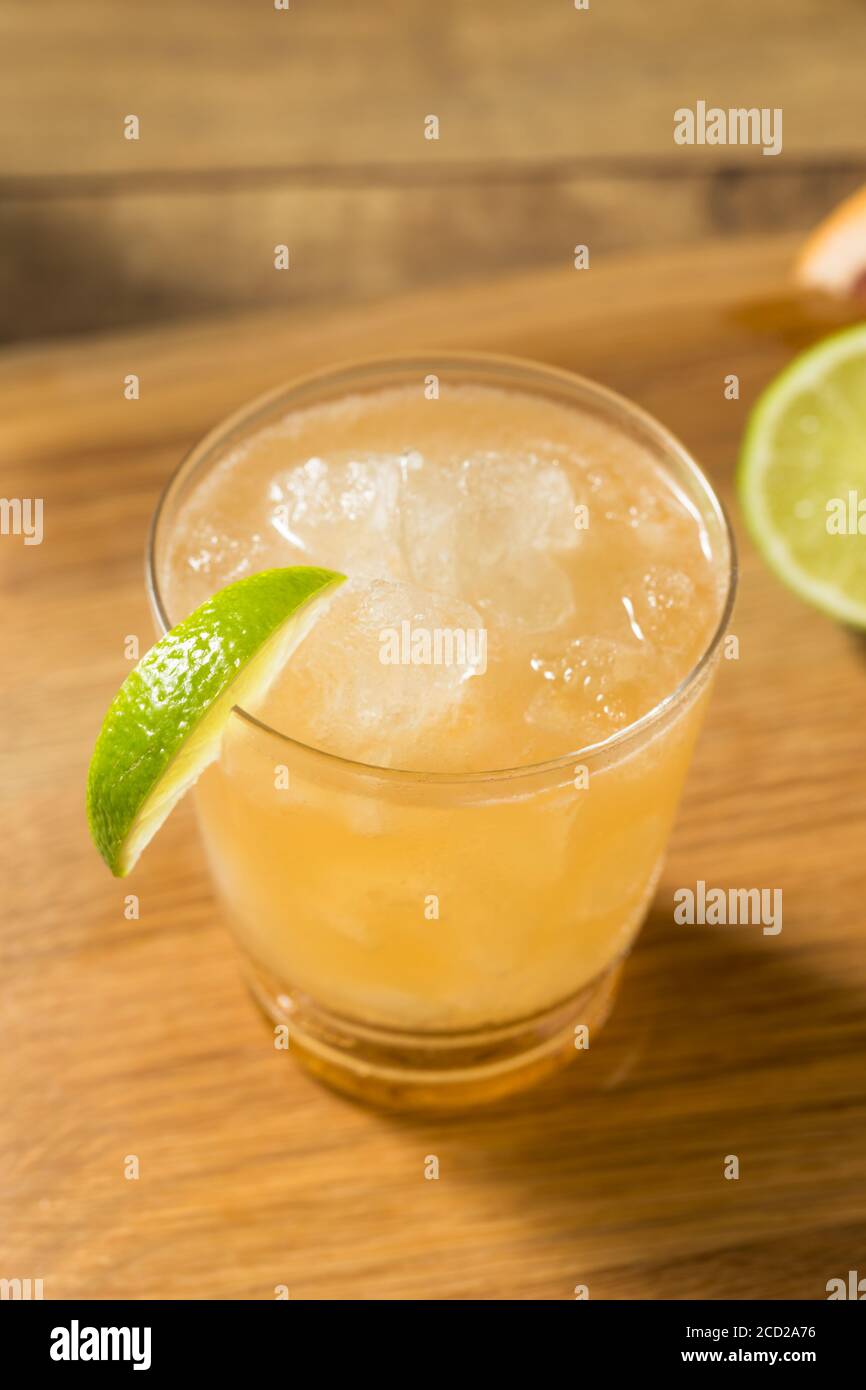 Boozy Refreshing Rum Navy Grog Cocktail with Lime and Grapefruit Stock