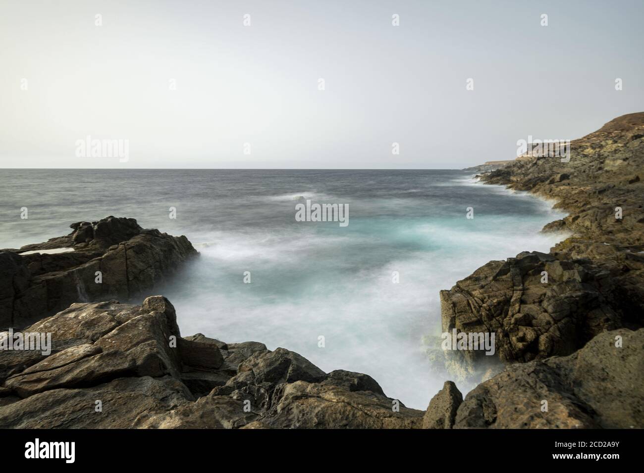 Rocky beach under cloudy sky Stock Photo - Alamy