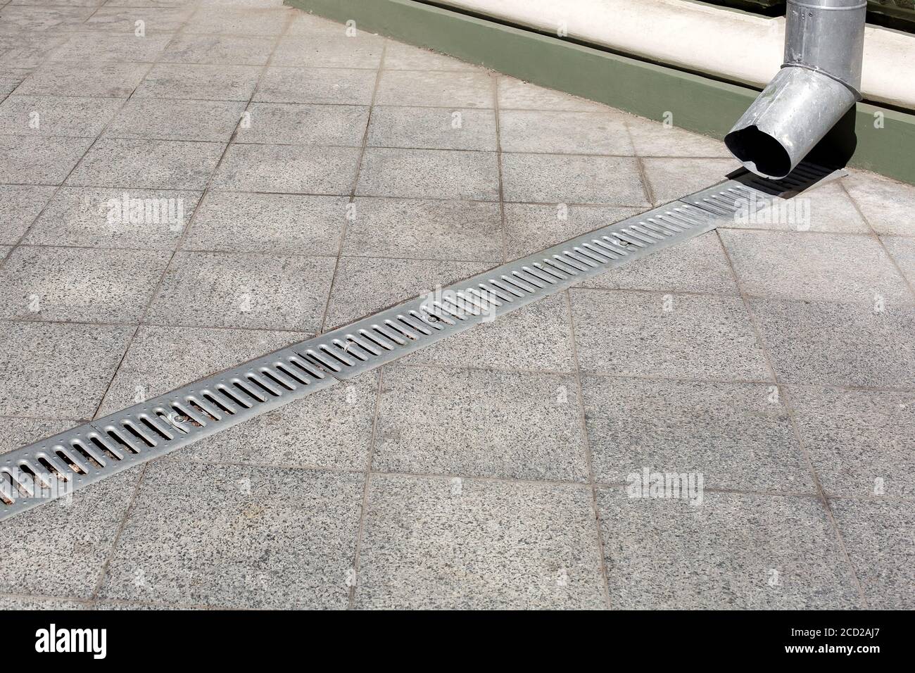 engineering structure downspout on facade building with drainage grate