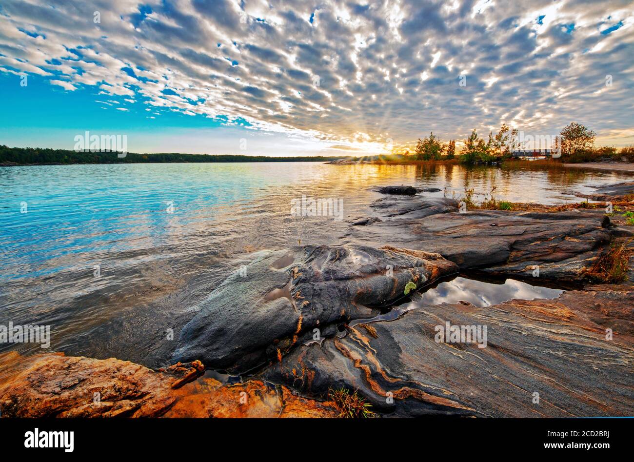 Dramatic metamorphic rock formations in Georgian Bay, Ontario, Canada, at sunset Stock Photo