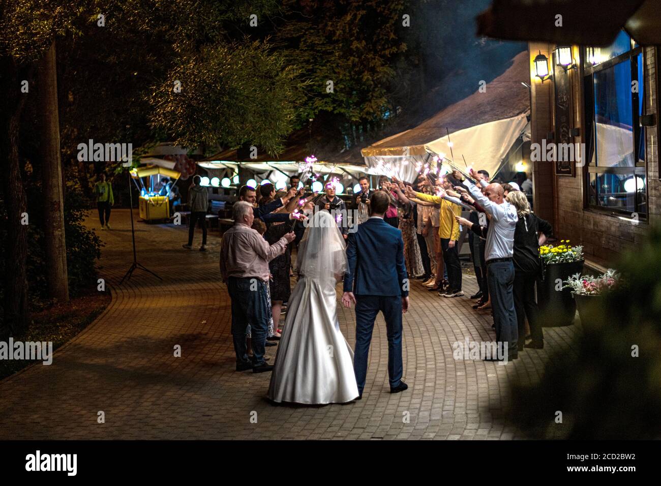 Guests Throwing Confetti Over Bride And Groom At Wedding Stock Photo Alamy