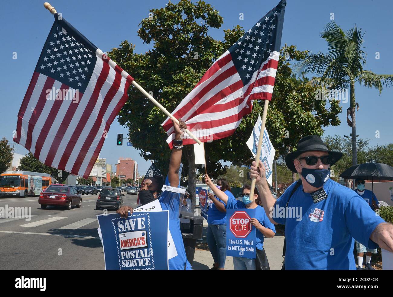 Los Angeles, USA. 25th Aug 2020. Postal workers rally to save the post office in opposition of Postmaster General Louis DeJoy's service changes within the U.S. Postal Service ahead of the November general election at the Bicentennial Post Office in the Fairfax area of Los Angeles on Tuesday, August 25, 2020. DeJoy, who became postmaster general June 16, has been accused of tampering with the nation's postal service by banning overtime, removing mail sorting equipment and prohibiting extra trips. Credit: UPI/Alamy Live News Stock Photo