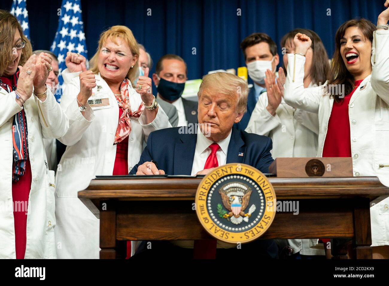 President Donald J. Trump is applauded as he signs a series of Executive Orders on lowering drug prices Friday, July 24, 2020, in the South Court Auditorium in the Eisenhower Executive Office Building at the White House. Stock Photo